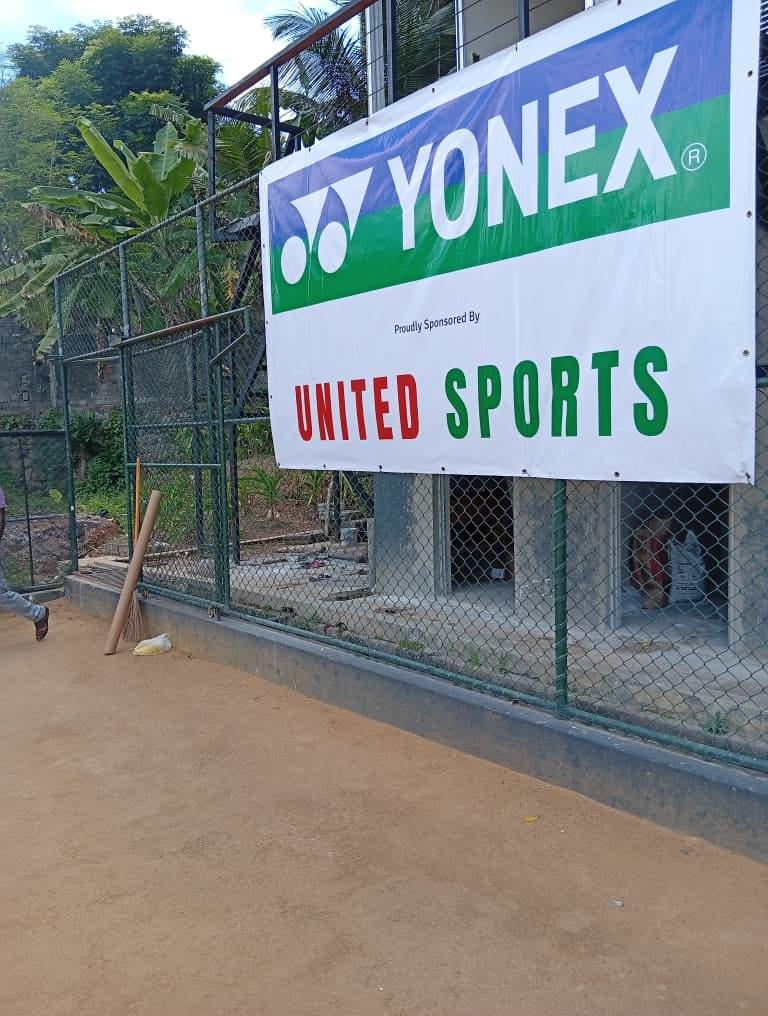 A YONEX banner reading 'Proudly sponsored by United Sports' on the academy fence
