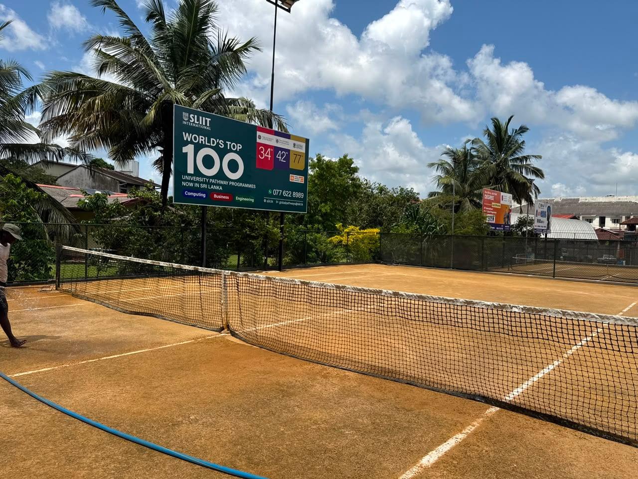 The net and courts before the sponsorship, surrounded by third-party billboards