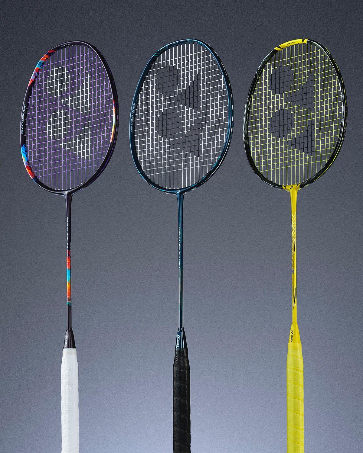 Three Yonex badminton rackets side by side on a deep blue background